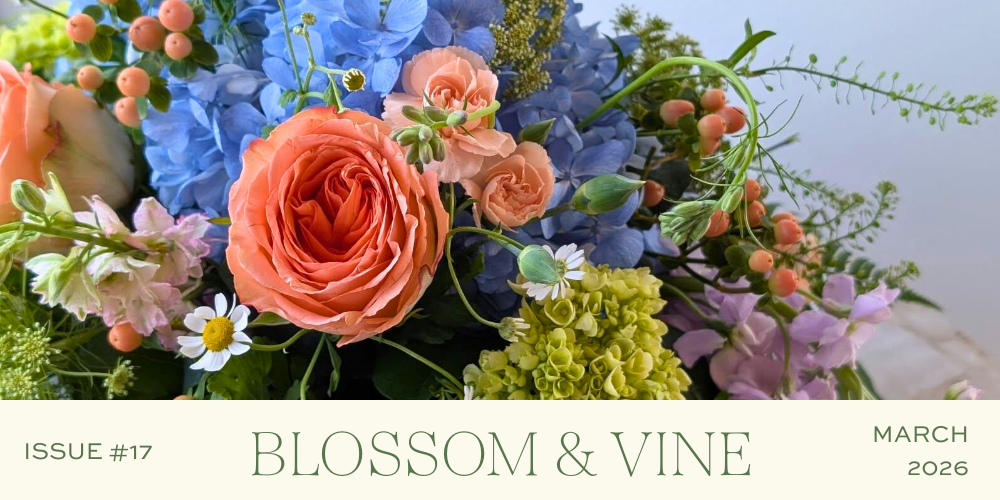 March 2026 Blossom & Vine newsletter cover featuring a colorful spring floral arrangement with roses, hydrangeas, berries, and seasonal blooms