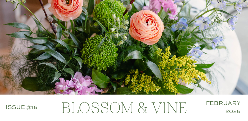 February 2026 Blossom & Vine newsletter cover featuring a colorful spring floral arrangement with peach ranunculus, blue delphinium, greenery, and seasonal blooms