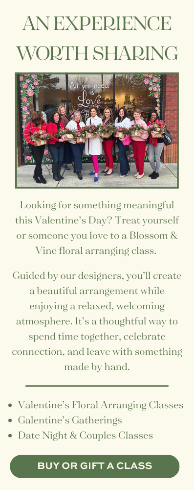 Participants holding floral arrangements outside Blossom & Vine during a Valentine's floral design class and group workshop