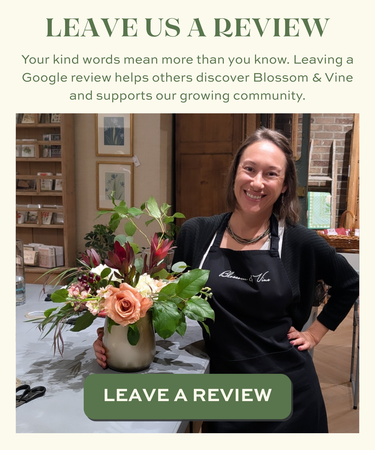 Blossom & Vine designer posing with a seasonal floral arrangement encouraging customers to leave a Google review
