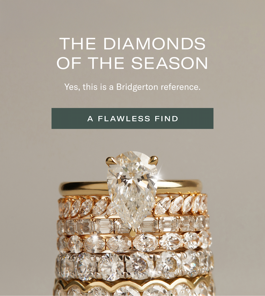 an image of a stack of gold and diamond rings with a diamond ring on top