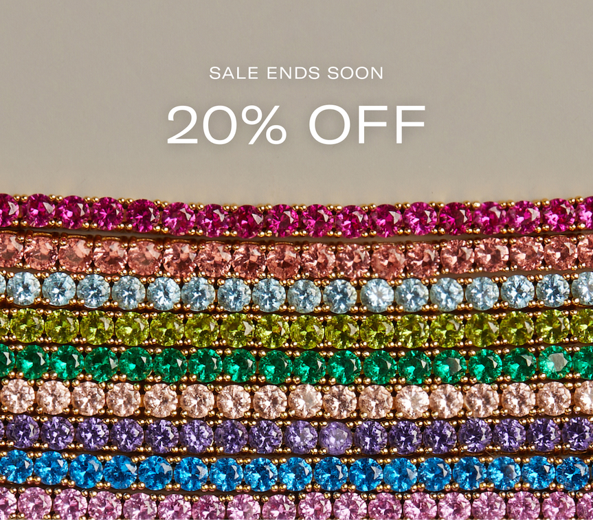 an image of a stack of gold and diamond rings with a diamond ring on top