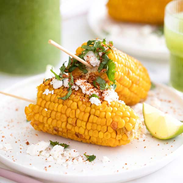A plate of elote, Mexican-style street corn. Photo by Karolin Baitinger on Unsplash.