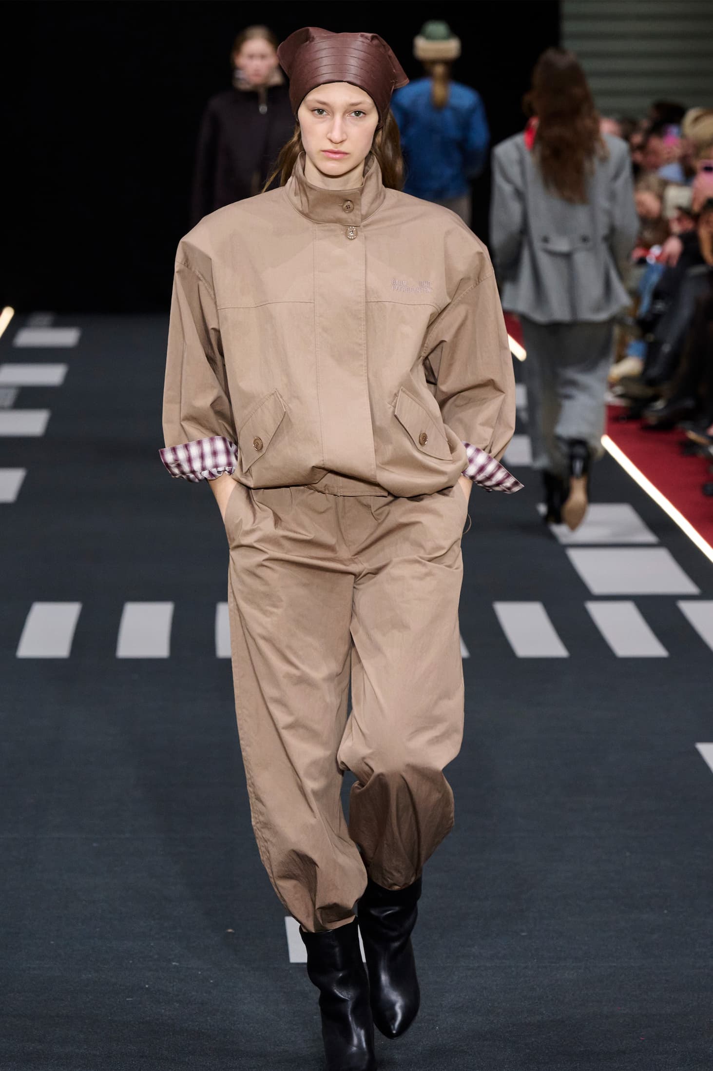 Girl on runway with beige jacket and pants