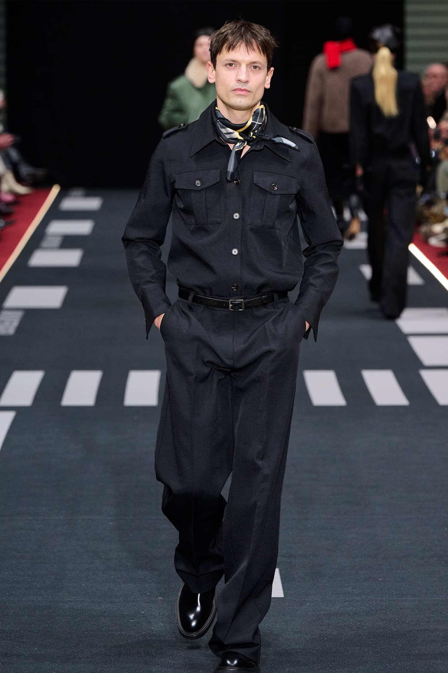 Boy on runway in black suited set 