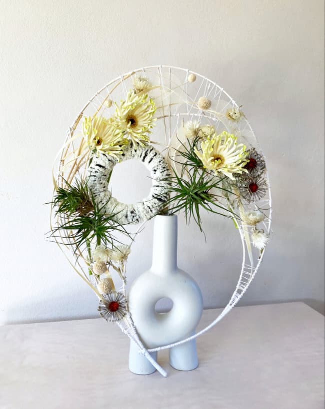 An arching floral design in a contemporary vase by Mary Fairlie-Cuninghame.