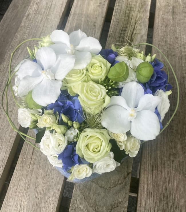 an image of a bouquet of flowers sitting on a wooden table