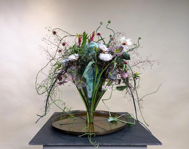 An arching floral design in a contemporary vase by Mary Fairlie-Cuninghame.