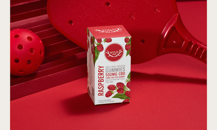 A box of Raspberry CBD gummies on a red table.