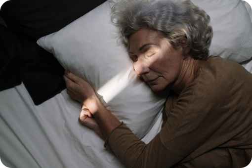 Older women sleeping in a bed
