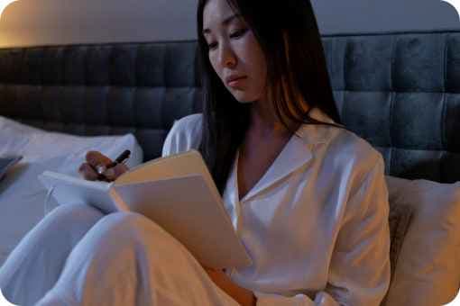 Women Journaling in Bed