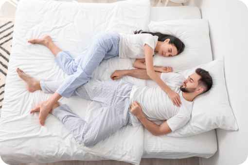 Couple sleeping on a bed