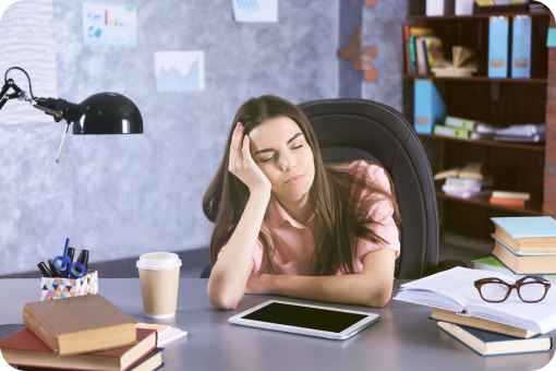 Woman falling asleep at her desk