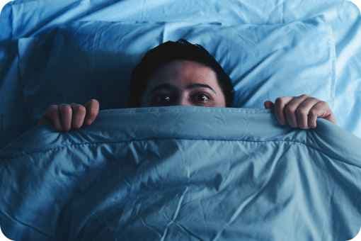 Person afraid in bed