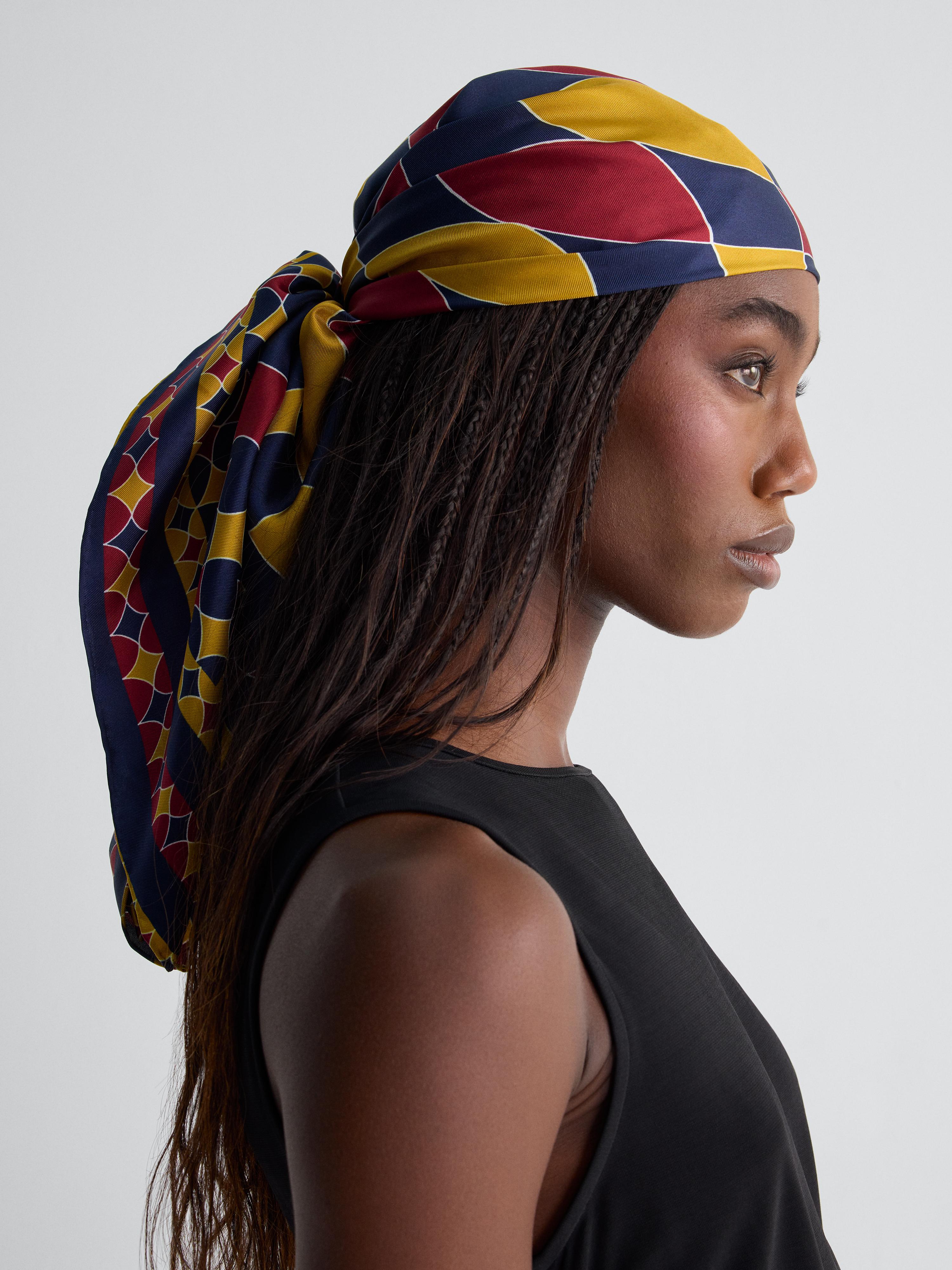 blue red and yellow scarf worn around head