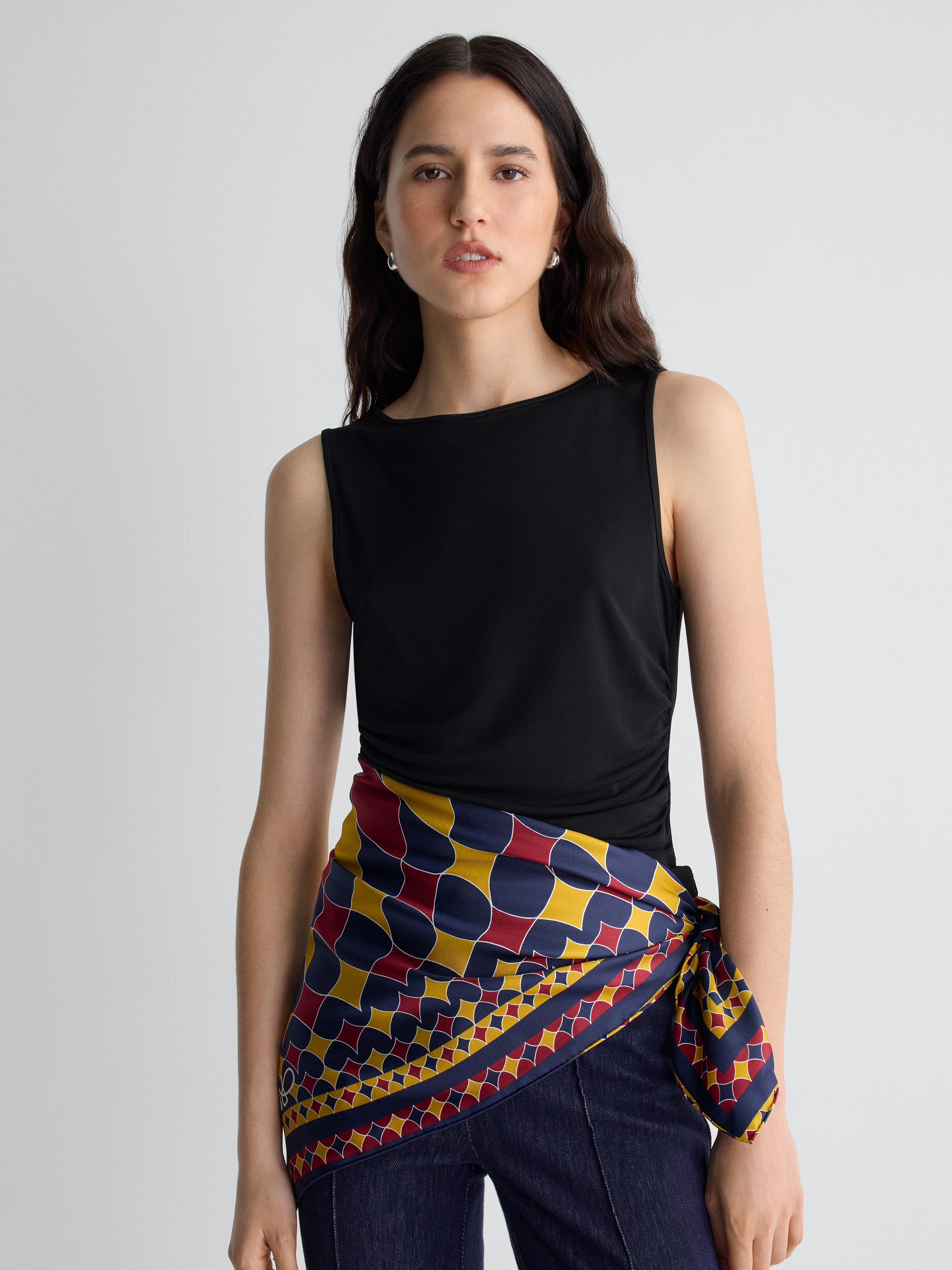 blue red and yellow scarf worn around waist on model