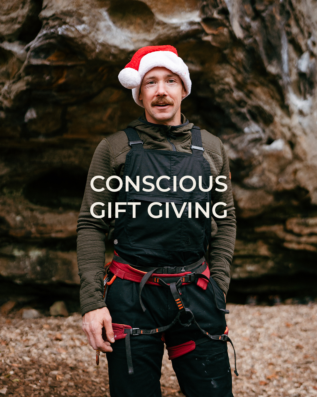 man wearing climbing harness and santa hat