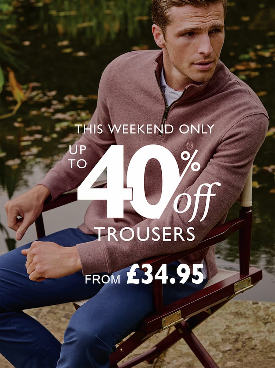 an image of a man sitting in a chair with a lake in the background