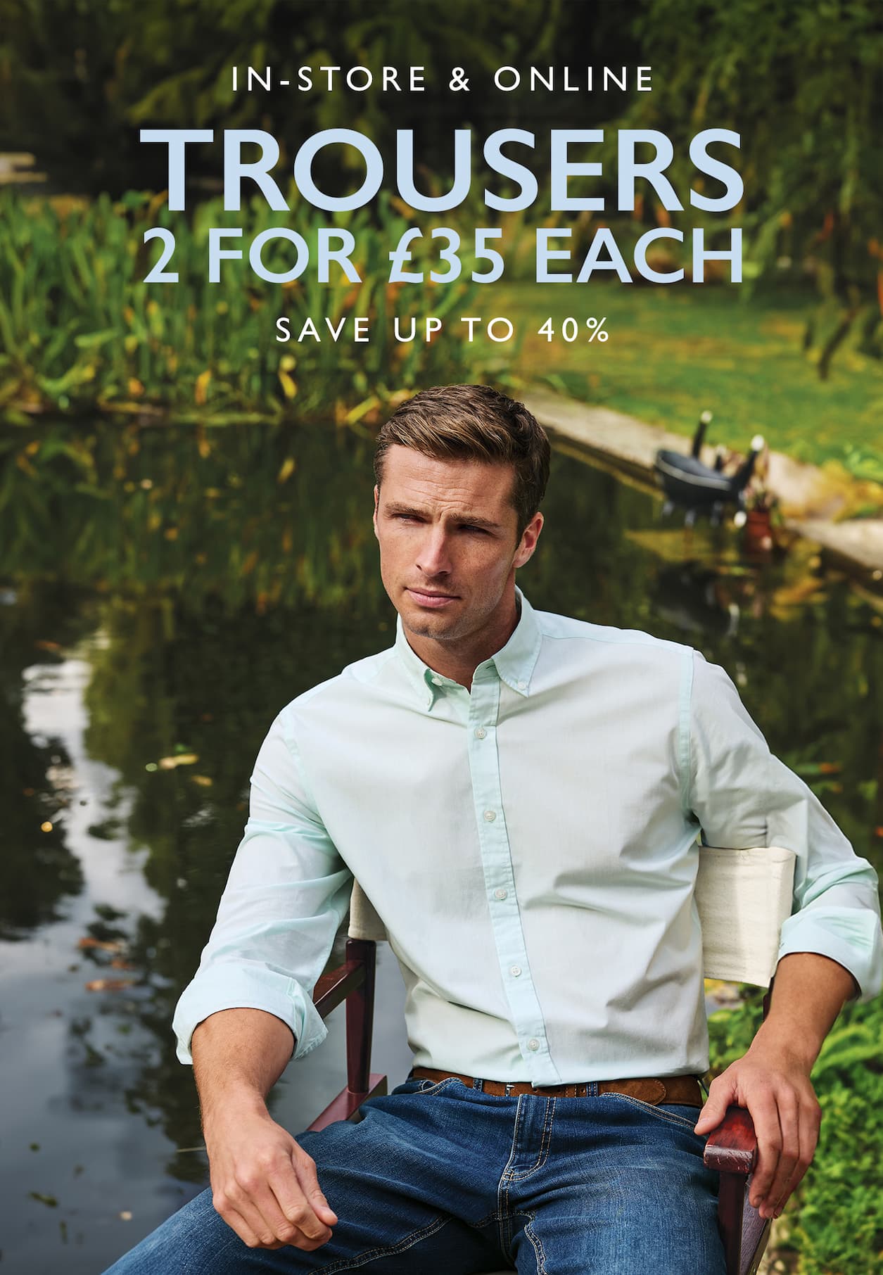 an image of a man sitting in a chair with a lake in the background