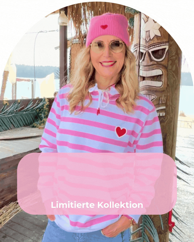 an image of two women in pink shirts and jeans posing for a picture