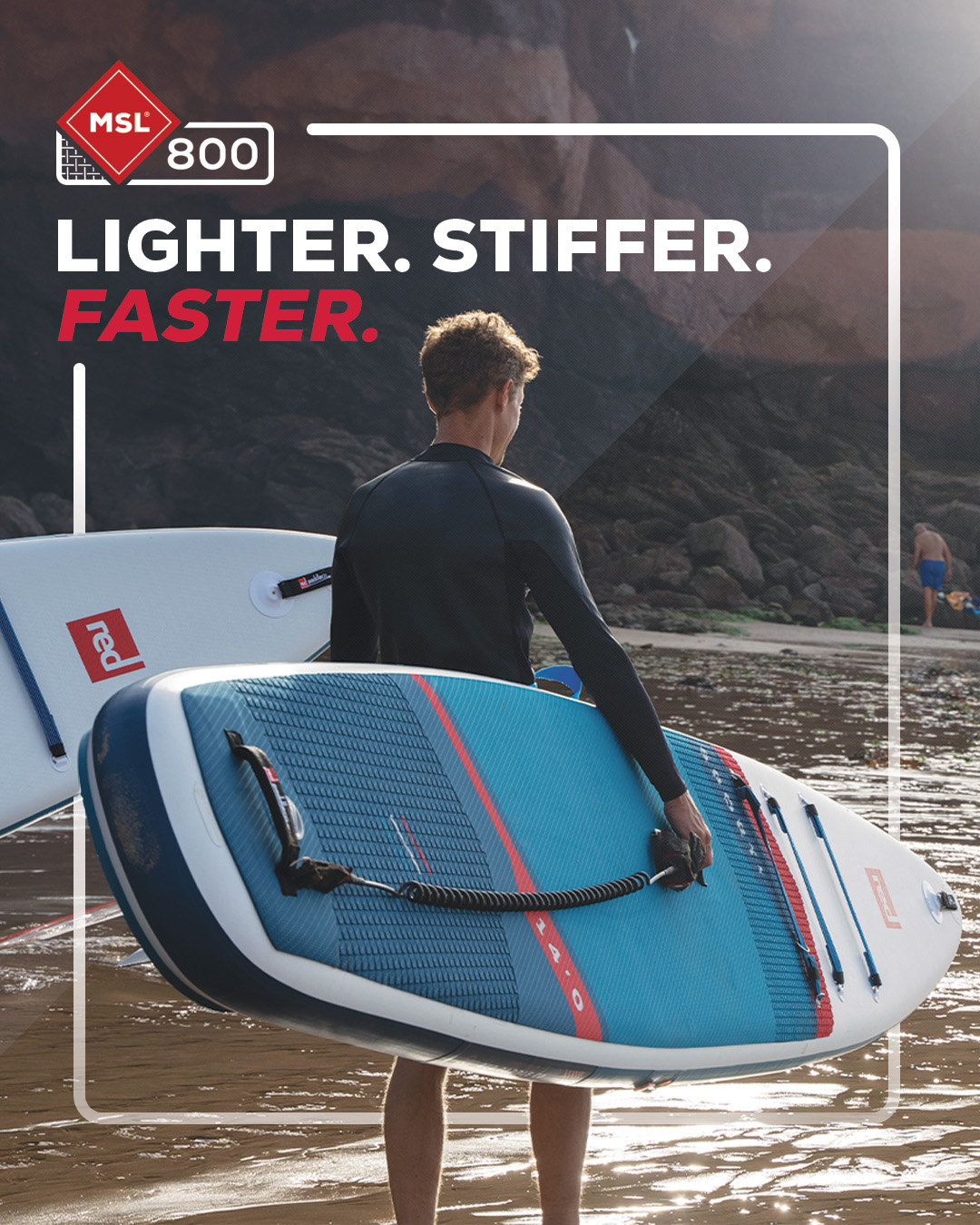 Man carrying a Red Paddle Co inflatable paddle board