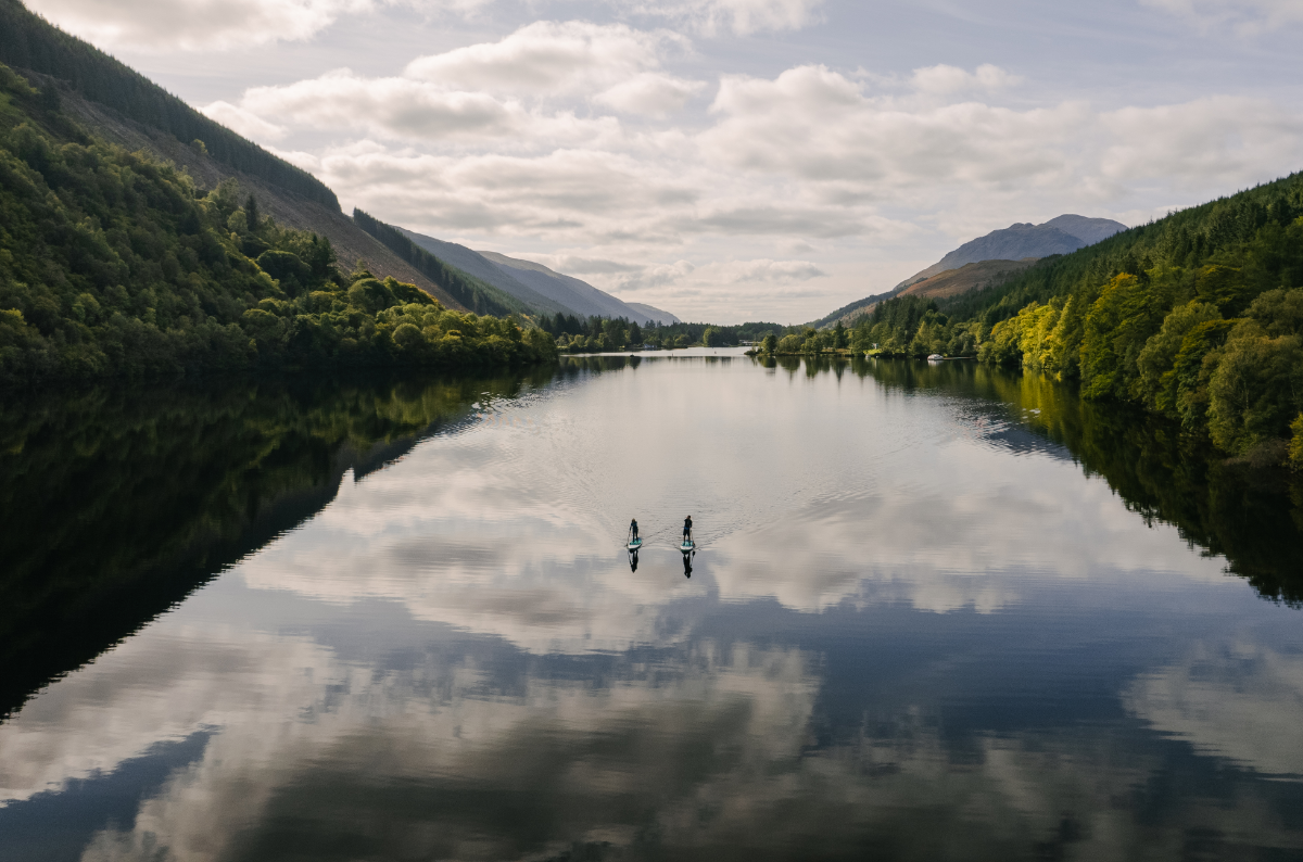 Two people with Red Paddle Co Voyager paddleboards on a Scottish Loch