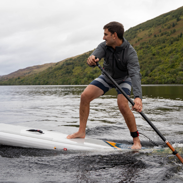 Man racing on Elite Red Paddle Co inflatable SUP