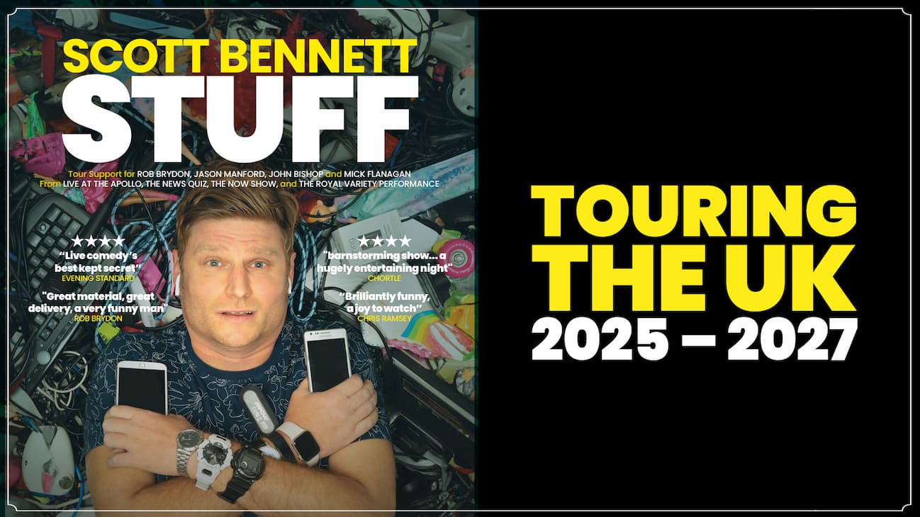 Promotional stand-up comedy poster featuring a person lying on their back surrounded by a cluttered pile of household items and electronics, including cables, phones, and keyboards. The person is positioned centrally, holding two smartphones with arms crossed, and wearing multiple watches on both wrists. Large bold text at the top reads “SCOTT BENNETT – STUFF.” Additional text highlights tour support credits and review quotes, with a banner at the bottom stating “Touring the UK 2025–2027.”