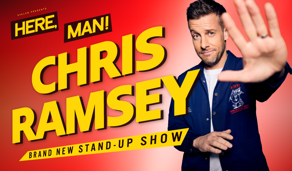 Promotional stand-up comedy poster featuring a person in a dark jacket on the right, with one hand raised toward the camera in a stop gesture. The background is a red-to-orange gradient. Large bold yellow text reads “CHRIS RAMSEY,” with smaller text above saying “HERE, MAN!” and a banner below stating “BRAND NEW STAND-UP SHOW.”