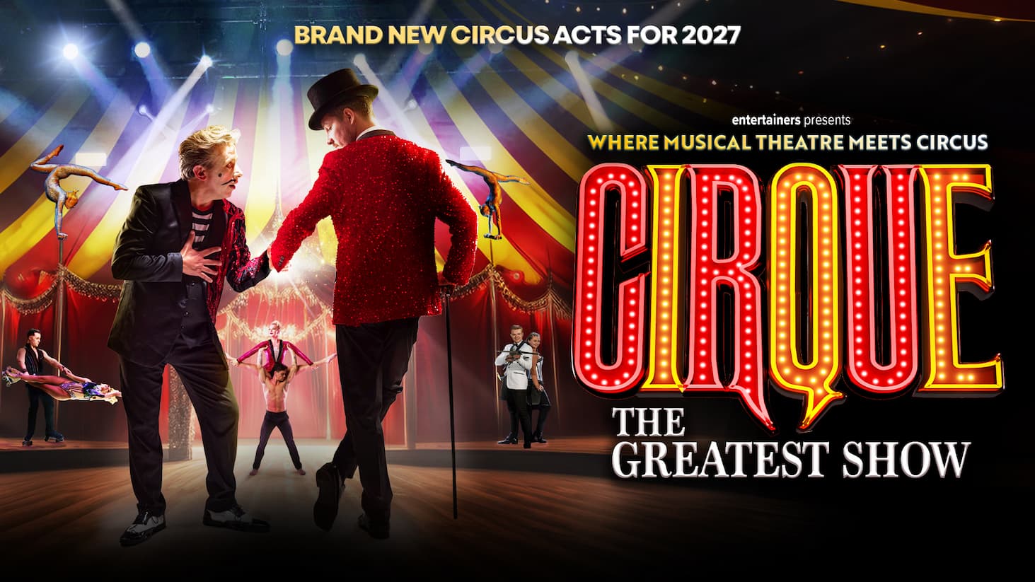 Promotional poster for a circus-themed stage show. The scene is set inside a brightly lit big-top tent with red drapes, spotlights, and colorful beams of light. Two performers stand prominently in the foreground on a stage: one wearing a black suit with red sequined lapels and theatrical makeup, and another wearing a sparkling red jacket, black top hat, and holding a cane. Around them are several circus acts, including acrobats balancing upside down, an aerial-style handstand performer, a partner acrobatic lift, and a duo performance near the center-right. Large illuminated marquee lettering on the right reads “CIRQUE”, with “THE GREATEST SHOW” below. Above the title, text reads “Where Musical Theatre Meets Circus” and “entertainers presents.” Across the top of the image, bold text states “BRAND NEW CIRCUS ACTS FOR 2027.” The overall design uses dramatic stage lighting, warm red and gold tones, and a theatrical circus atmosphere.