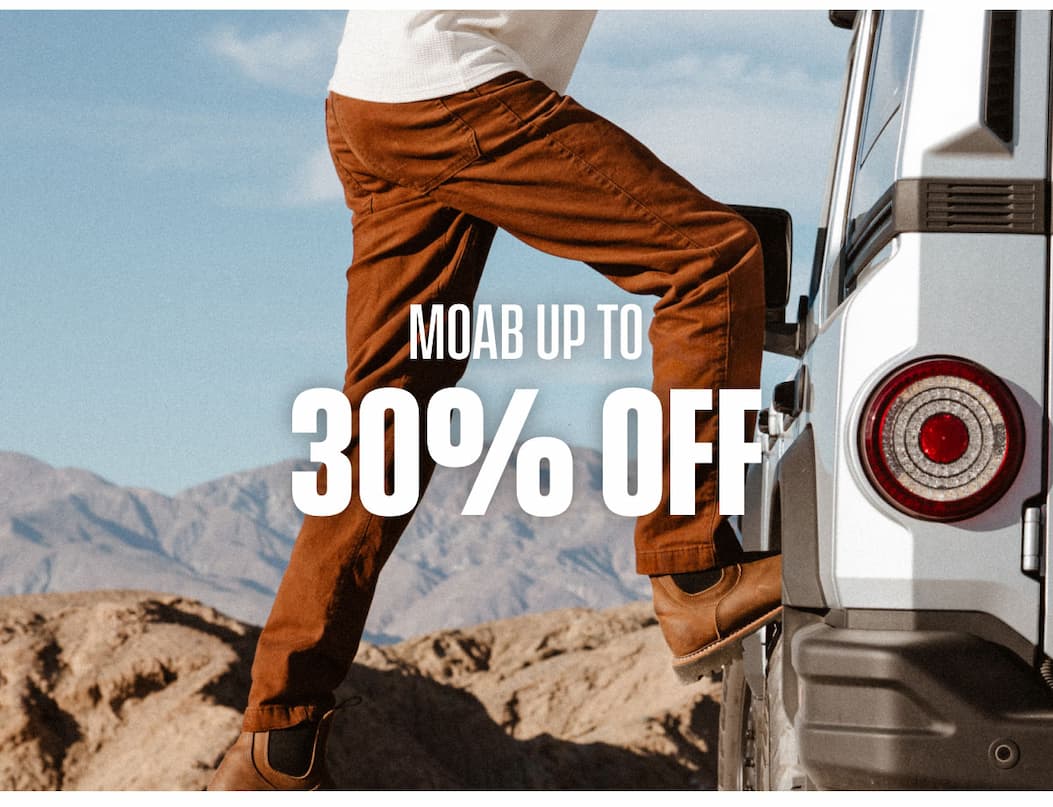 MOAB up to 30% off promo showing brown MOAB pants stepping into an off-road vehicle.