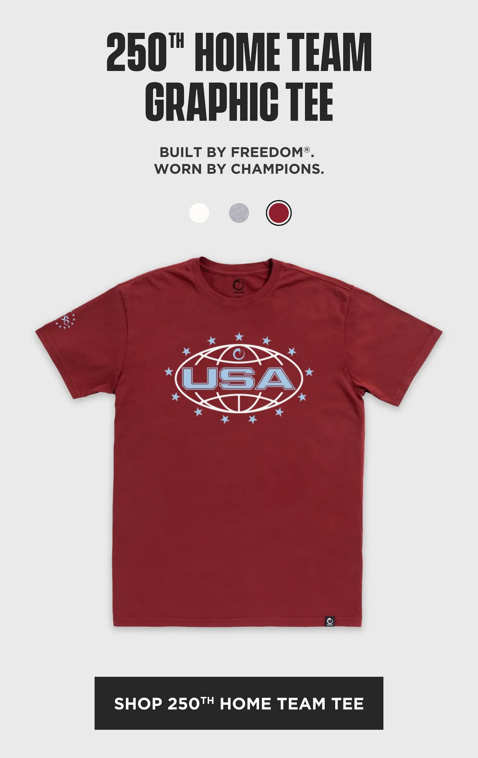 Red 250th Home Team graphic T-shirt with a large USA logo on the chest, shown on a gray background with the headline “250th Home Team Graphic Tee,” copy reading “Built by Freedom. Worn by champions.,” color swatches above, and a black “Shop 250th Home Team Tee” button.