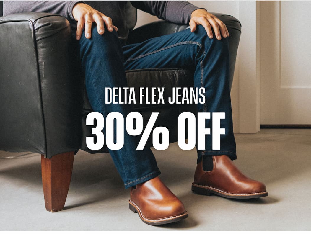 Delta Flex Jeans 30% off promo showing dark denim jeans with brown Chelsea boots.
