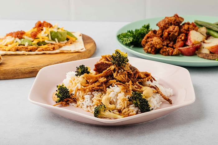 Chicken over rice with broccoli and flatbread
