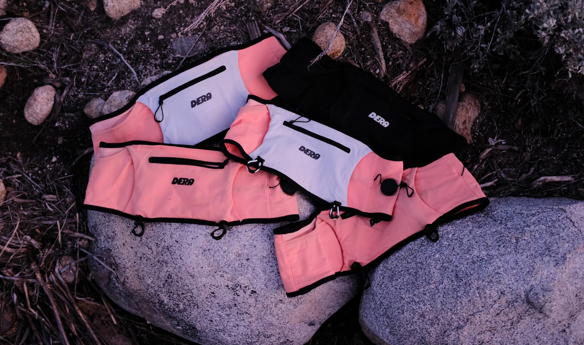 Five running belts laid out on a rock