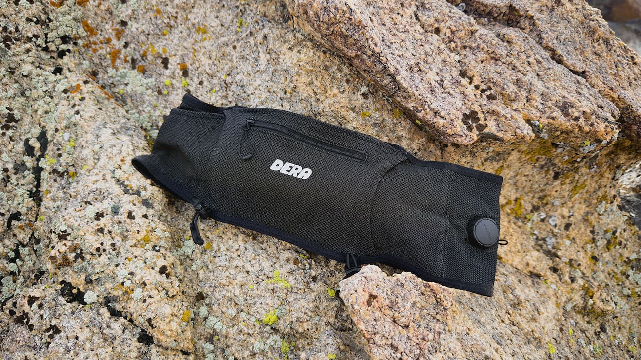 A black running belt sitting on a mossy rock