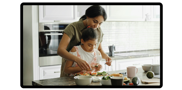 Food influencer in a kitchen filming, holding avocado toast