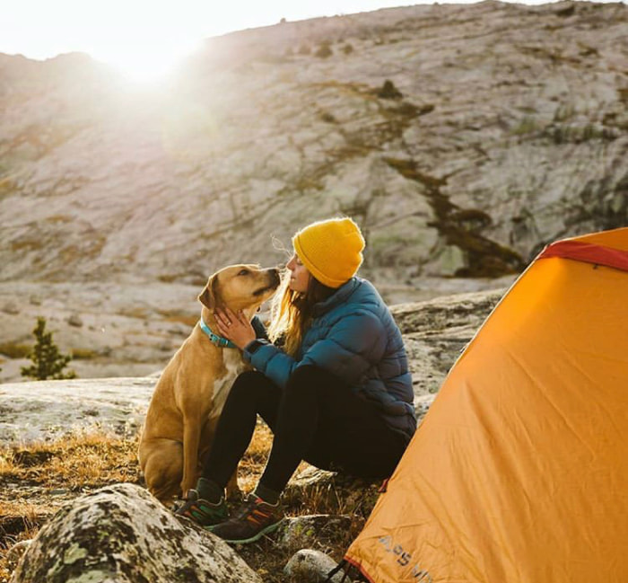 girl camping with dog
