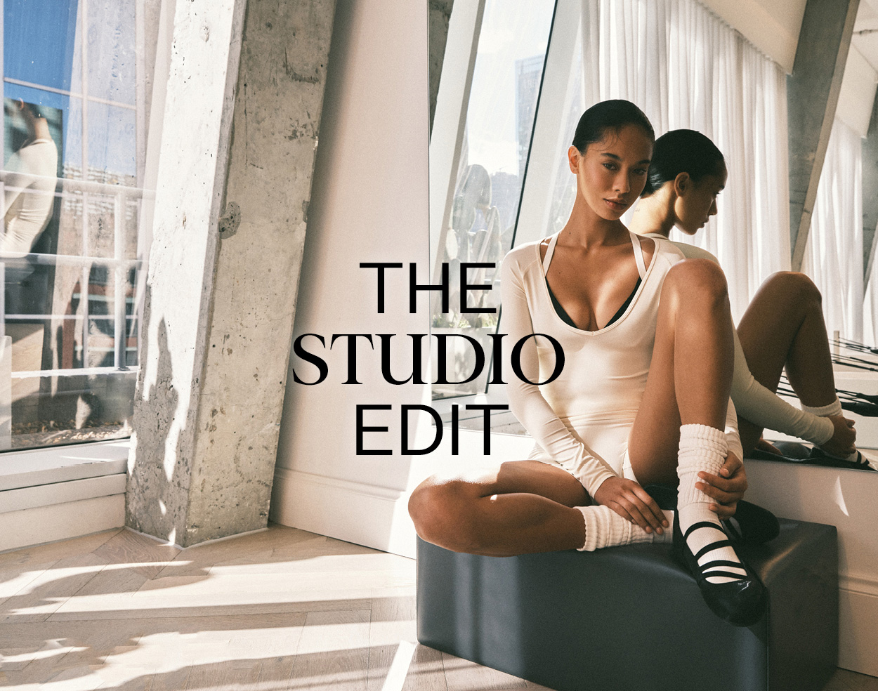 Girl sitting on pilates box in studio