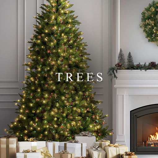 Decorated Christmas tree with multicolor lights beside a fireplace and wrapped presents.