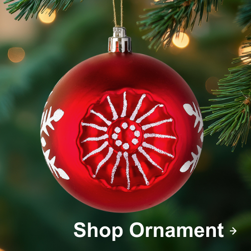 Red Christmas ornament with white snowflake design hanging on a pine tree branch.