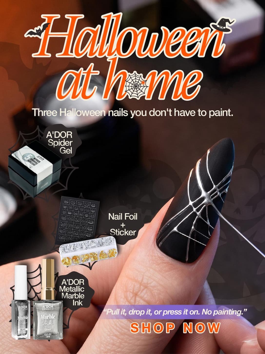 Close-up of a hand pulling a silver spider gel web across a black gel nail at a home table