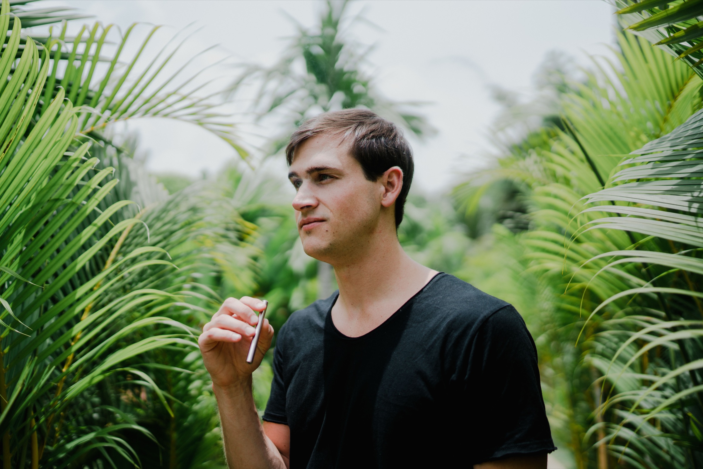 Man breathing in lush tropical botanical surroundings — reconnecting the olfactory system to the plant compounds it evolved to receive