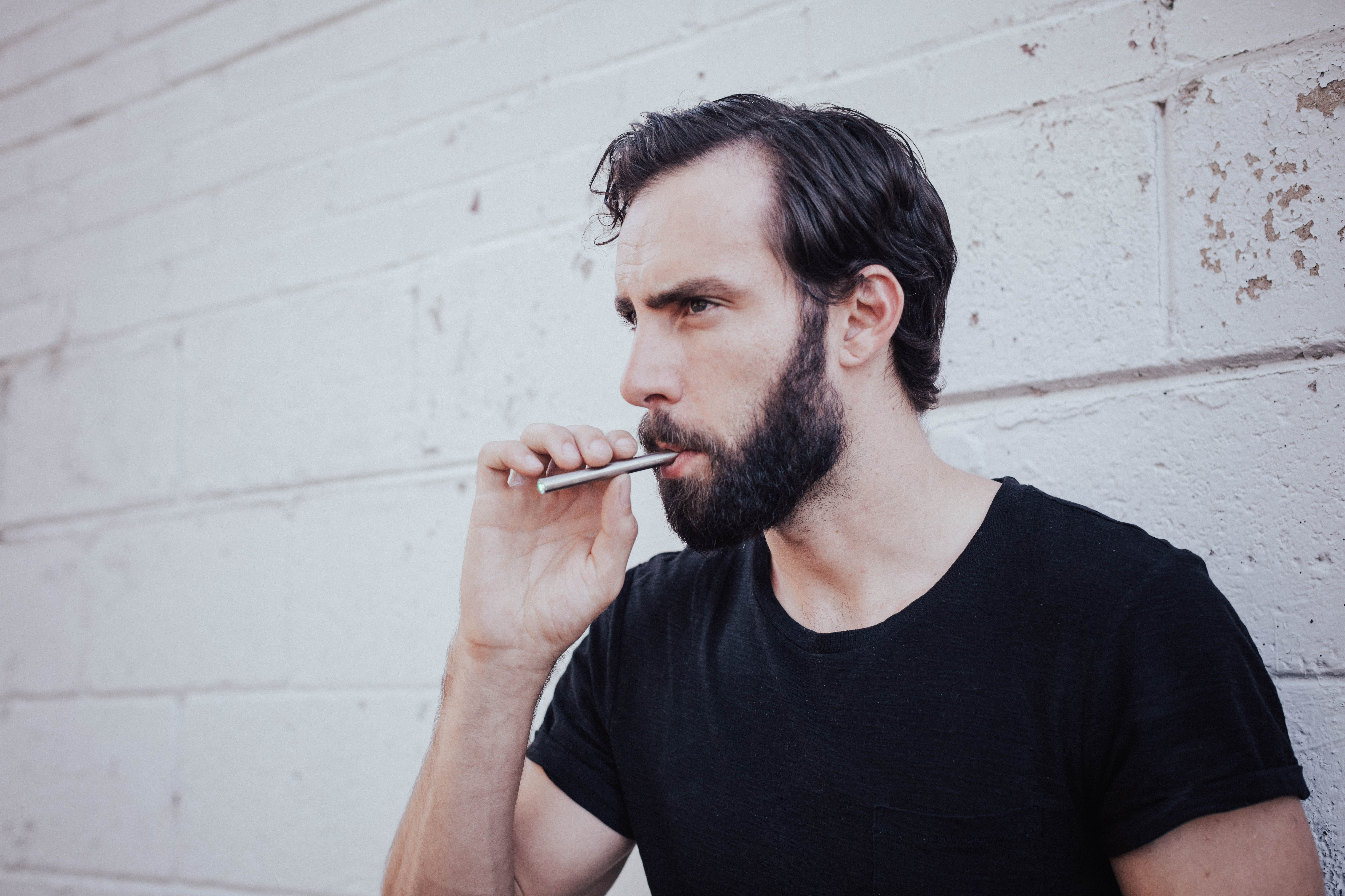 Man with eyes closed inhaling MONQ — the introspective moment of scent-triggered memory, the Proust Effect in action