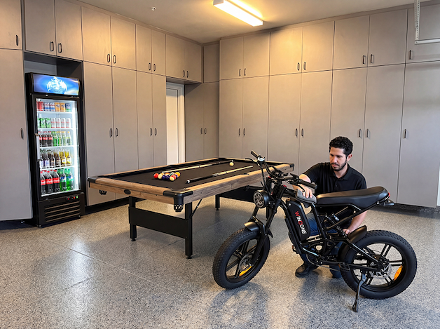 A dad enjoying a pool table or outdoor recreation space.