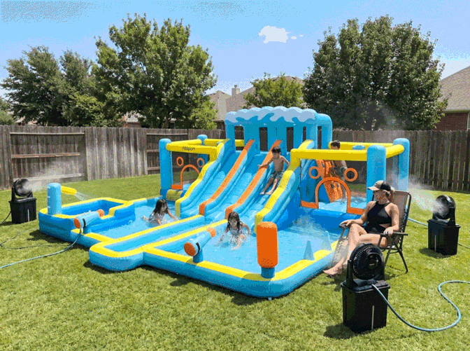 A backyard inflatable water slide set up for a summer afternoon.
