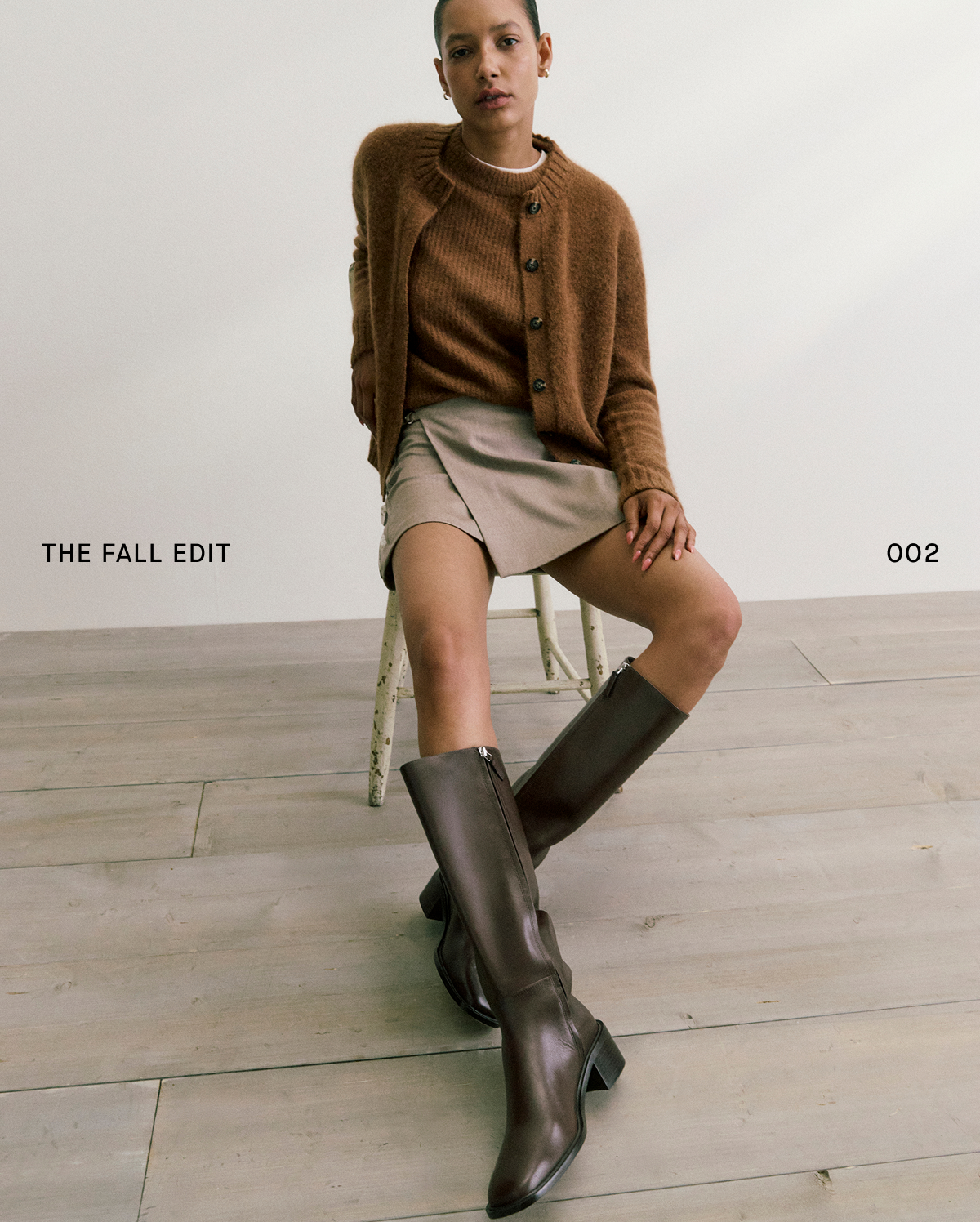 Image | The Fall Edit 002 | Model in Wrap Mini Skort in Tailor Twill, The Crew Cardigan in Alpaca, The Cocoon Crew in Alpaca, and Leather Knee-High City Boot.