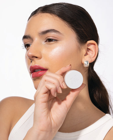 Promotional image of a woman with a cosmetic product