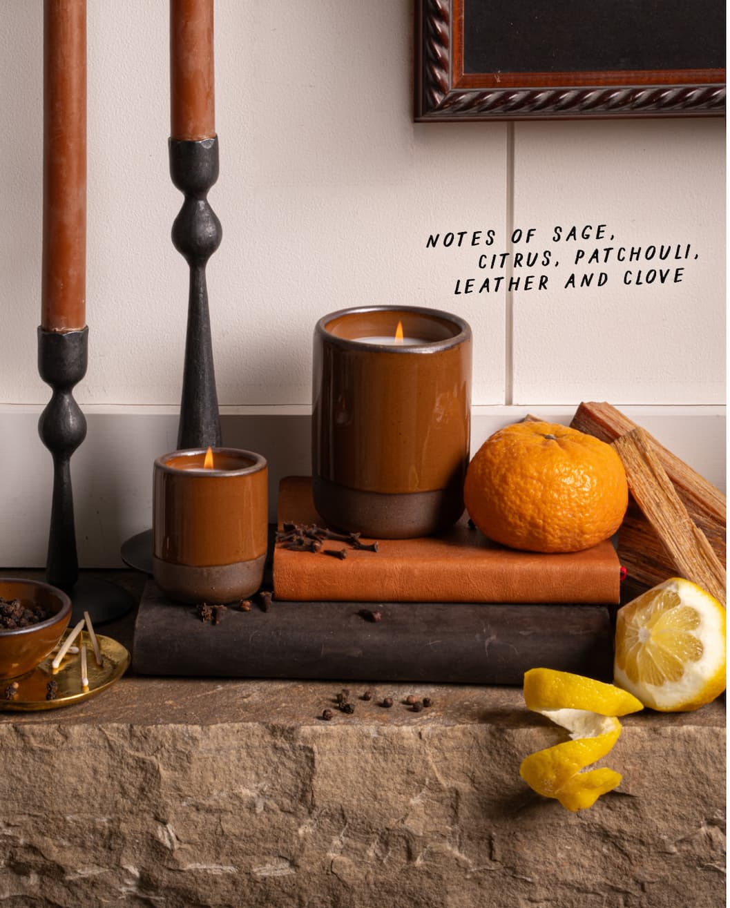 Brownstone Candle - Notes of sage, citrus, patchouli, leather and clove. 