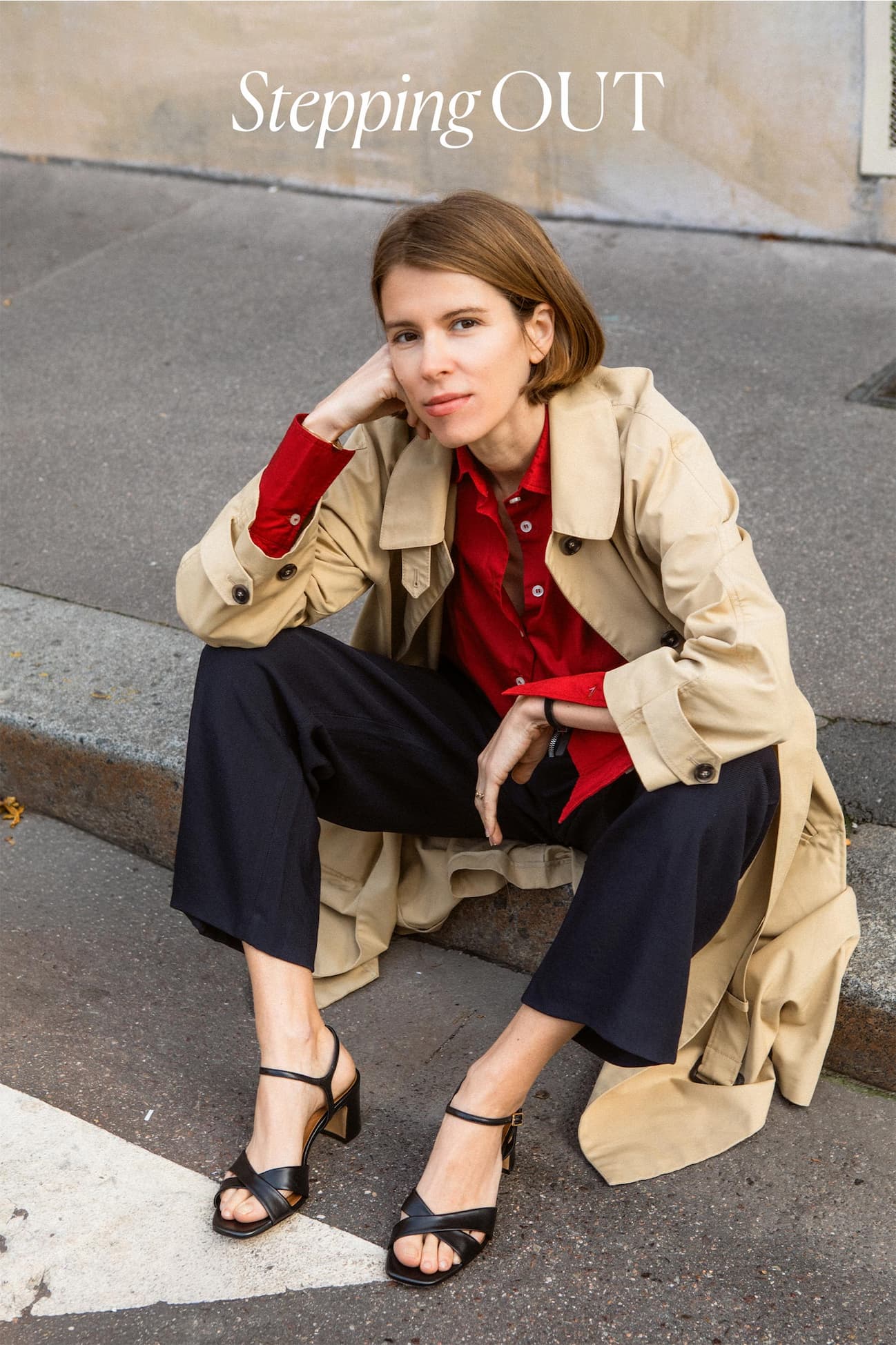 an image of a woman sitting on the steps of a building